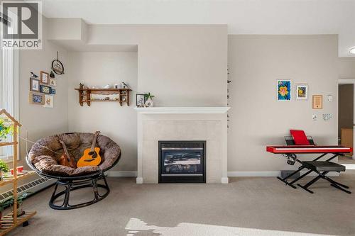 2207, 1888 Signature Park Sw, Calgary, AB - Indoor With Fireplace