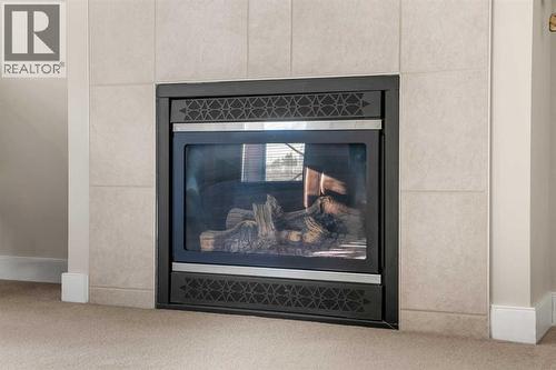 2207, 1888 Signature Park Sw, Calgary, AB - Indoor With Fireplace