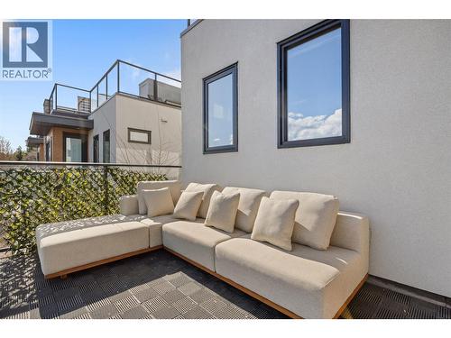 Second Bedroom, used as theater room. The projector screen comes down over the blinds. - 1818 Peak Point Court Unit# 16, West Kelowna, BC - Indoor Photo Showing Bedroom