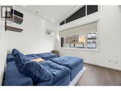 Second Bedroom, used as theater room. The projector screen comes down over the blinds. - 