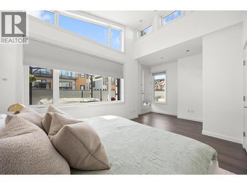 A virtual staging of the last photo. This is bedroom 2. The closet would have to be built out where the current sauna is, unlike what you see in this photo. - 1818 Peak Point Court Unit# 16, West Kelowna, BC - Indoor Photo Showing Bedroom