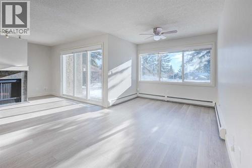 1, 101 Village Heights Sw, Calgary, AB - Indoor With Fireplace