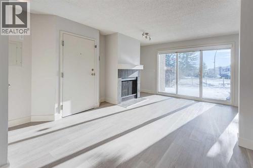 1, 101 Village Heights Sw, Calgary, AB - Indoor With Fireplace