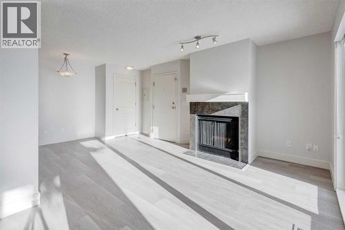 1, 101 Village Heights Sw, Calgary, AB - Indoor With Fireplace