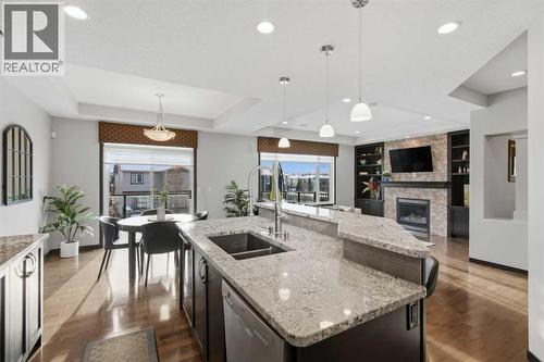 71 Panatella View Nw, Calgary, AB - Indoor Photo Showing Kitchen With Fireplace With Double Sink With Upgraded Kitchen