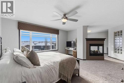 71 Panatella View Nw, Calgary, AB - Indoor Photo Showing Bedroom With Fireplace