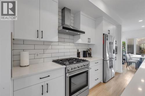 Upgraded Bricklay Backsplash - 213 Greenbriar Common Nw, Calgary, AB - Indoor Photo Showing Kitchen With Stainless Steel Kitchen With Upgraded Kitchen