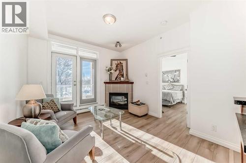 3217, 24 Hemlock Crescent Sw, Calgary, AB - Indoor Photo Showing Living Room With Fireplace