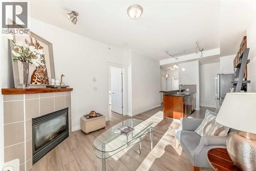 3217, 24 Hemlock Crescent Sw, Calgary, AB - Indoor Photo Showing Living Room With Fireplace