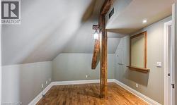 Additional living space with hardwood / wood-style floors and vaulted ceiling - 