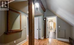 Corridor featuring light wood-style floors and baseboards - 