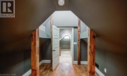 Additional living space featuring light wood-type flooring and lofted ceiling - 