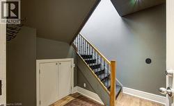 Stairs featuring wood finished floors and baseboards - 