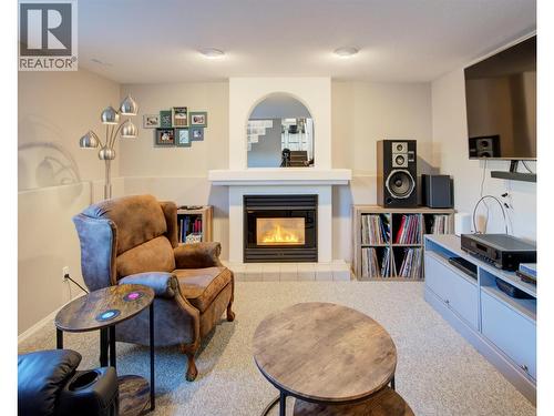 Family room on lower level - 2312 Hunter Avenue, Armstrong, BC - Indoor Photo Showing Living Room With Fireplace
