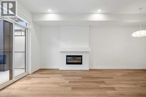 202, 550 Seton Circle Se, Calgary, AB - Indoor With Fireplace