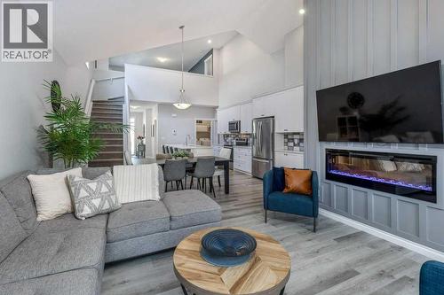 380 Rivercrest View, Cochrane, AB - Indoor Photo Showing Living Room With Fireplace