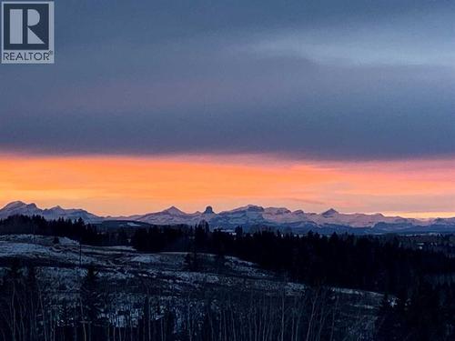 Gorgeous mountain sunsets - Devil's Head Mountain takes center stage in this upper level shot to the West - 380 Rivercrest View, Cochrane, AB - Outdoor With View