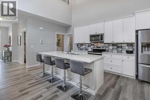 380 Rivercrest View, Cochrane, AB - Indoor Photo Showing Kitchen With Stainless Steel Kitchen