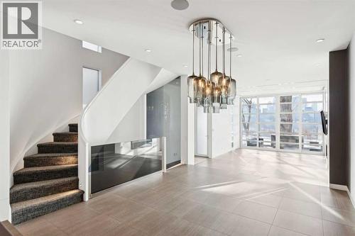SCULPTURAL CUSTOM STAIRCASE CONNECTS ALL LEVELS - 530 Crescent Road Nw, Calgary, AB - Indoor Photo Showing Other Room