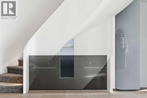 SMOKED GLASS PANELS PLUS A CURVED GLASS PANEL - 530 Crescent Road Nw, Calgary, AB - Indoor Photo Showing Other Room