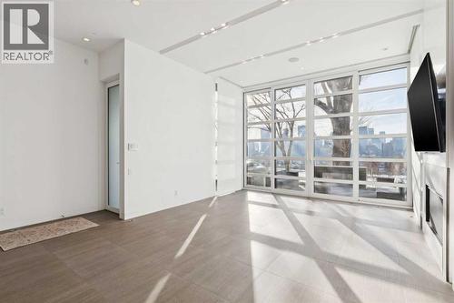 2 SLIDING PANELS OPEN TO CREATE A SEAMLESS INDOOR-OUTDOOR CONNECTION TO THE FRONT TERRACE. POWER SUN-PRIVACY SHADES - 530 Crescent Road Nw, Calgary, AB - Indoor Photo Showing Other Room