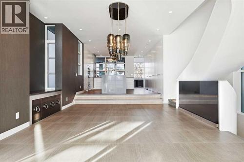 DINING ROOM WITH DESIGNER LIGHTING AND SERVING STATION-STORAGE TO THE SIDE - 530 Crescent Road Nw, Calgary, AB - Indoor Photo Showing Other Room