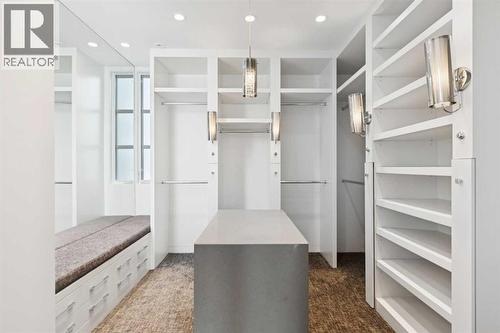 CUSTOM-DESIGNED WALK-IN CLOSET AND DRESSING ROOM.  LOTS OF DRAWERS.  ADDITIONAL BACK OF CLOSETS NOT SHOWN - 530 Crescent Road Nw, Calgary, AB - Indoor