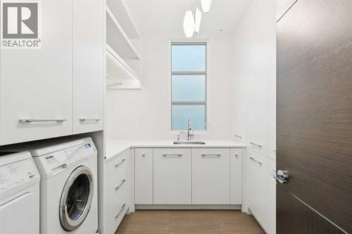 LAUNDRY ROOM WITH EXCELLENT STORAGE NEXT TO THE PRIMARY - 530 Crescent Road Nw, Calgary, AB - Indoor Photo Showing Laundry Room