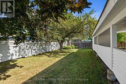 Beautiful side yard with mature trees and garden - 