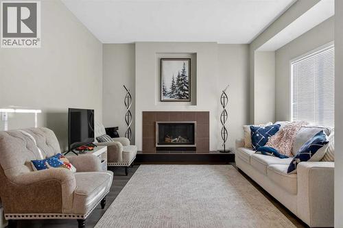 146 Marquis Common Se, Calgary, AB - Indoor Photo Showing Living Room With Fireplace