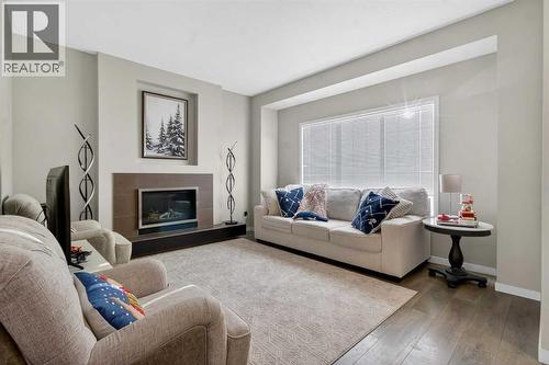 146 Marquis Common Se, Calgary, AB - Indoor Photo Showing Living Room With Fireplace