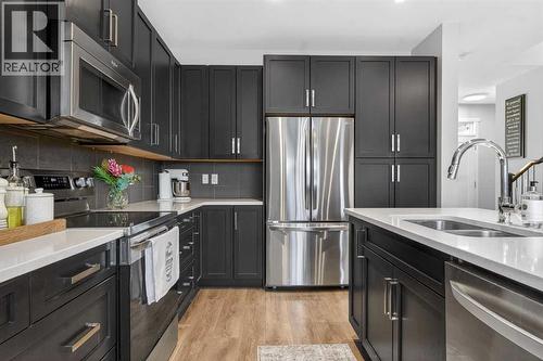 146 Marquis Common Se, Calgary, AB - Indoor Photo Showing Kitchen With Double Sink With Upgraded Kitchen