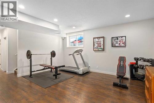 Basement rec. area - 112 Sunset View, Cochrane, AB - Indoor Photo Showing Gym Room
