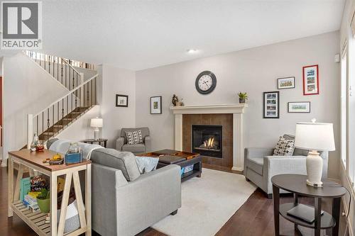 112 Sunset View, Cochrane, AB - Indoor Photo Showing Living Room With Fireplace
