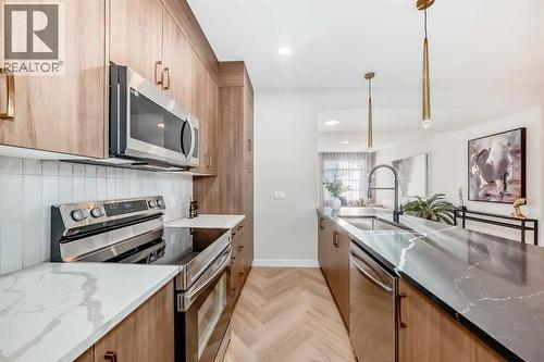 94 Agate Road, Cochrane, AB - Indoor Photo Showing Kitchen With Upgraded Kitchen