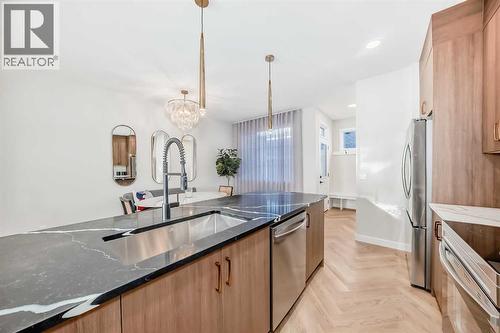 94 Agate Road, Cochrane, AB - Indoor Photo Showing Kitchen With Double Sink With Upgraded Kitchen