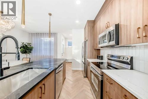94 Agate Road, Cochrane, AB - Indoor Photo Showing Kitchen With Upgraded Kitchen