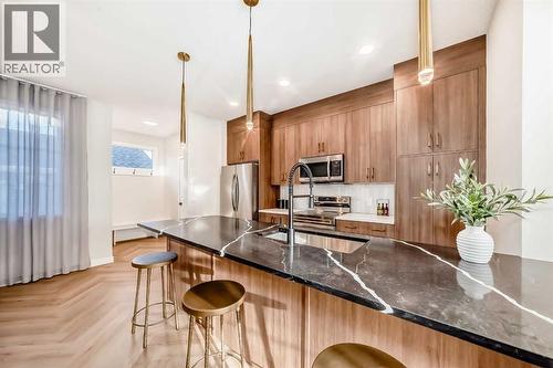 94 Agate Road, Cochrane, AB - Indoor Photo Showing Kitchen With Upgraded Kitchen