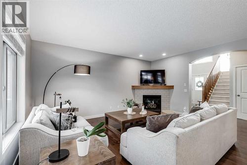 31 St Moritz Terrace Sw, Calgary, AB - Indoor Photo Showing Living Room With Fireplace