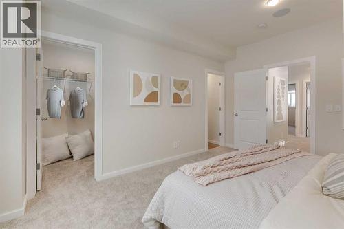PLEASE NOTE: Photos are of a finished Showhome of the same model – fit and finish may differ on finished spec home. Interior selections and floorplans shown in photos - 62 Starling Boulevard Nw, Calgary, AB - Indoor Photo Showing Bedroom