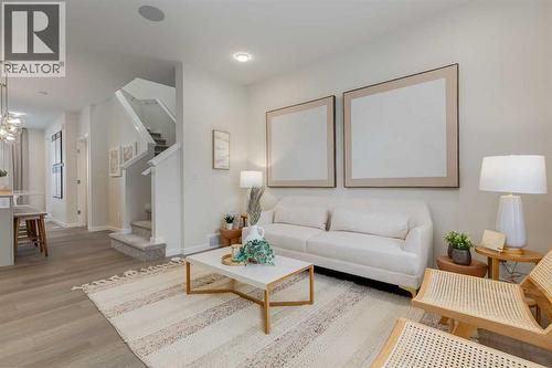 PLEASE NOTE: Photos are of a finished Showhome of the same model – fit and finish may differ on finished spec home. Interior selections and floorplans shown in photos - 62 Starling Boulevard Nw, Calgary, AB - Indoor Photo Showing Living Room