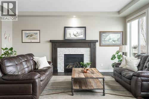 52 Elgin Estates View Se, Calgary, AB - Indoor Photo Showing Living Room With Fireplace