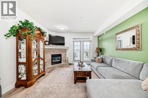 111, 1005B Westmount Drive, Strathmore, AB - Indoor Photo Showing Living Room With Fireplace
