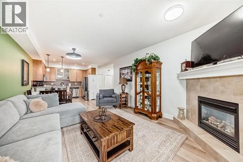 111, 1005B Westmount Drive, Strathmore, AB - Indoor Photo Showing Living Room With Fireplace