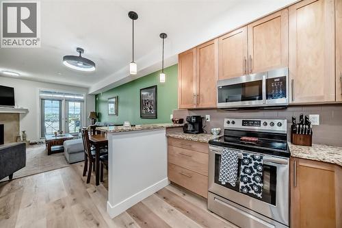 111, 1005B Westmount Drive, Strathmore, AB - Indoor Photo Showing Kitchen With Fireplace