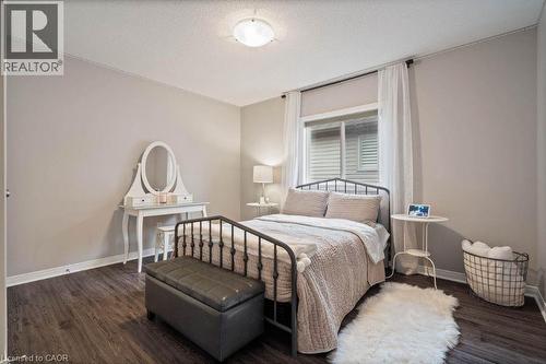 Bedroom featuring dark wood-style floors and a textured ceiling - 151 Fair Street, Ancaster, ON 