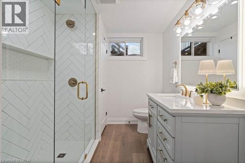Bathroom featuring a stall shower, vanity, and dark wood-type flooring - 151 Fair Street, Ancaster, ON 