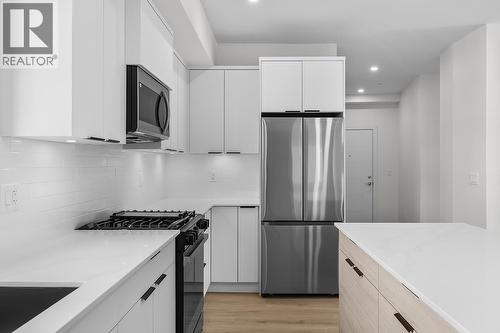 Photos may be of a similar home in the community - 5300 Main Street Unit# 204, Kelowna, BC - Indoor Photo Showing Kitchen With Stainless Steel Kitchen With Upgraded Kitchen