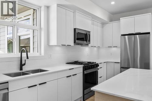 Photos may be of a similar home in the community - 5300 Main Street Unit# 204, Kelowna, BC - Indoor Photo Showing Kitchen With Stainless Steel Kitchen With Double Sink With Upgraded Kitchen