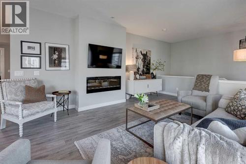 405 Cranbrook Walk Se, Calgary, AB - Indoor Photo Showing Living Room With Fireplace
